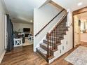 Staircase features wood treads, an iron railing, and built-in storage at 8200 Lansford Rd, Charlotte, NC 28277
