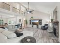 Spacious living room with a vaulted ceiling, fireplace, and abundant natural light at 959 Robinson Rd, Gastonia, NC 28056