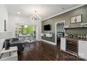 Cozy living area with unique decor, stylish wet bar and access to windowed breakfast nook at 1025 Ardsley Rd # 103, Charlotte, NC 28207