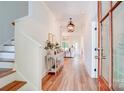 Inviting foyer with wood floors, elegant lighting, and a glimpse into the open-concept living space at 1030 Little Cowgirl Ln, Cleveland, NC 27013