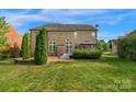 Spacious backyard featuring a well-maintained lawn, patio area, and lush greenery, perfect for outdoor entertaining at 1116 Crooked River Dr, Waxhaw, NC 28173