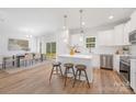 Bright kitchen featuring an island with barstool seating and stainless steel appliances at 1148 Thayer Glen Ct, Charlotte, NC 28213