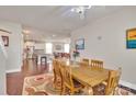 Open-concept dining area with hardwood floors, natural light, and views of the kitchen and living room at 121 Martingale Ave, Mooresville, NC 28115