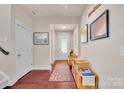 Bright foyer with hardwood floors, white trim, art, and natural light welcomes you into this beautiful home at 121 Martingale Ave, Mooresville, NC 28115