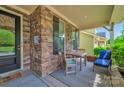 Charming front porch with stone columns, seating, and a welcome mat creates an inviting entrance to the home at 121 Martingale Ave, Mooresville, NC 28115