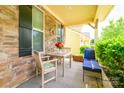Cozy porch area with a stone facade and seating for outdoor relaxation, featuring flowers at 121 Martingale Ave, Mooresville, NC 28115