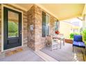 Cozy porch area with a stone facade and seating for outdoor relaxation, featuring flowers at 121 Martingale Ave, Mooresville, NC 28115