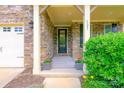 Inviting front porch with stone accents, space for seating and a beautiful entry door at 121 Martingale Ave, Mooresville, NC 28115