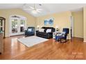 Open-concept living room with hardwood floors, vaulted ceiling, and access to the outdoor area at 1666 Sam Smith Rd, Fort Mill, SC 29708