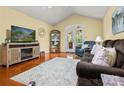 Cozy living room showcasing hardwood floors, a decorative fireplace, and plenty of natural light from French doors at 1666 Sam Smith Rd, Fort Mill, SC 29708