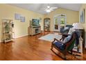 Bright living room featuring hardwood floors, ceiling fan, and a comfortable rocking chair, offering a warm ambiance at 1666 Sam Smith Rd, Fort Mill, SC 29708