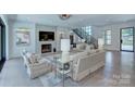 Beautifully furnished living room with fireplace, modern decor, and hardwood floors at 1919 Shoreham Dr, Charlotte, NC 28211