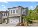 Charming two-story home with a two-car garage and manicured landscaping, set on a sunny day at 2034 Suttonview Rd, Fort Mill, SC 29708