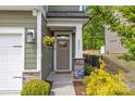 Inviting front porch with decorative plants and stone accents leading to the front door at 2034 Suttonview Rd, Fort Mill, SC 29708