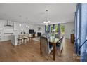 Bright open-concept living space with hardwood floors, fireplace, and large windows at 2034 Suttonview Rd, Fort Mill, SC 29708