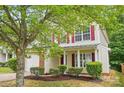 Charming two-story home featuring red shutters, manicured landscaping, and a welcoming front entrance at 2530 Cochrane Dr, Charlotte, NC 28269