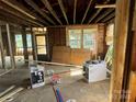 A room under renovation exposing the framework and awaiting completion with new windows at 334 Whitner St, Rock Hill, SC 29730