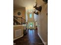Welcoming two-story foyer with hardwood floors, staircase, chandelier, and deer head mounts at 4203 Flint Dr, Lancaster, SC 29720