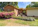 The backyard features a brick home, patio, and lush azalea bushes, creating a private outdoor space at 437 Old Mountain Rd, Statesville, NC 28677