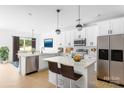 Bright, modern kitchen featuring white cabinets, stainless steel appliances, and a quartz island at 5125 Carden Dr, Charlotte, NC 28227