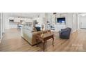 Open-concept living space with modern furnishings, wood floors, and built-in cabinets at 5247 Looking Glass Trl, Denver, NC 28037