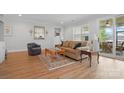 Inviting living room featuring hardwood floors, neutral paint, stylish furnishings and sliding glass doors at 5247 Looking Glass Trl, Denver, NC 28037