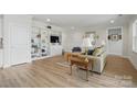 Bright living room with hardwood floors, built-in bookshelves, and a cozy seating area at 5247 Looking Glass Trl, Denver, NC 28037