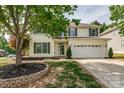 Charming two-story home with manicured lawn and attached two-car garage at 6001 Pine Cone Ln, Monroe, NC 28110