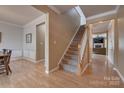 Inviting foyer features hardwood floors and a staircase leading to the upper level at 6001 Pine Cone Ln, Monroe, NC 28110