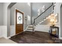 Elegant foyer with hardwood floors, staircase, and decorative front door with lots of detail at 618 Chase Ct, Fort Mill, SC 29708