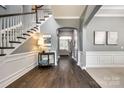 Open foyer featuring hardwood floors, arched doorways, white trim, and staircase at 618 Chase Ct, Fort Mill, SC 29708