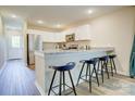 Modern kitchen with white cabinets, granite countertops, stainless steel appliances, and a breakfast bar with stylish stools at 809 Fisher St, Kannapolis, NC 28027