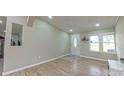 Well-lit living room featuring fresh paint and durable flooring at 8140 Karriker Rd, Kannapolis, NC 28081