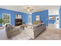 Cozy living room with a brick fireplace and neutral furnishings, offering a welcoming atmosphere at 1046 Linneys Mill Rd, Union Grove, NC 28689