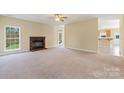 Spacious living room featuring a brick fireplace and large windows for natural light at 1046 Linneys Mill Rd, Union Grove, NC 28689