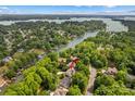Stunning aerial view of a lakeside home nestled among lush greenery, showcasing its prime waterfront location at 110 Preserve Way, Mooresville, NC 28117