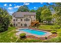 Stunning backyard featuring a swimming pool, landscaped yard, and deck, perfect for outdoor entertaining at 110 Preserve Way, Mooresville, NC 28117