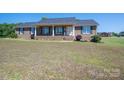 Charming brick home featuring a welcoming front porch and well-maintained landscaping at 118 Sir Gregory Dr, Shelby, NC 28152
