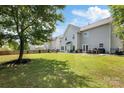 Large backyard features a well-maintained lawn, patio area, and mature tree providing ample shade at 1210 Langdon Terrace Dr, Indian Trail, NC 28079