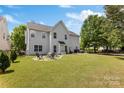 Spacious backyard with a fire pit area, outdoor seating, and a well-maintained lawn at 1210 Langdon Terrace Dr, Indian Trail, NC 28079