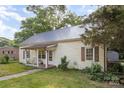 Charming home with metal roof, vinyl siding, and inviting front porch, nestled on a grassy lawn at 1221 Patterson St, Shelby, NC 28152