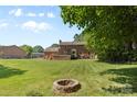Spacious backyard with a fire pit, perfect for outdoor gatherings and relaxation at 16565 Kimbolten Dr, Huntersville, NC 28078