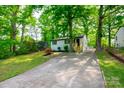 Exterior view of house surrounded by green trees and a long driveway at 1750 Oak Valley Dr, Gastonia, NC 28054