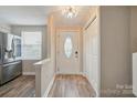 Bright entryway features wood flooring, chandelier, and a decorative front door at 202 Water Oak Dr, Pineville, NC 28134