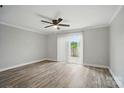 Open living room with wood floors and sliding glass doors to the outside patio at 202 Water Oak Dr, Pineville, NC 28134