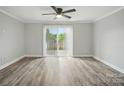Open living room with wood floors and sliding glass doors to the outside patio at 202 Water Oak Dr, Pineville, NC 28134
