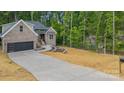 Well-designed house featuring a long driveway, a two-car garage, and manicured landscaping at 2108 Lakeview Cir, Matthews, NC 28105