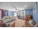 Inviting living room featuring hardwood floors, a comfortable sofa, and ample natural light at 250 Log Barn Rd, Salisbury, NC 28146