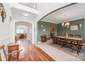 Open-concept dining room featuring hardwood floors, decorative lighting, and stylish decor at 306 Fesperman Cir, Troutman, NC 28166