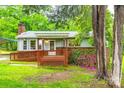 Inviting front exterior of a light blue home with a cozy covered porch and mature trees at 3491 Mcconnells Hwy, Rock Hill, SC 29732